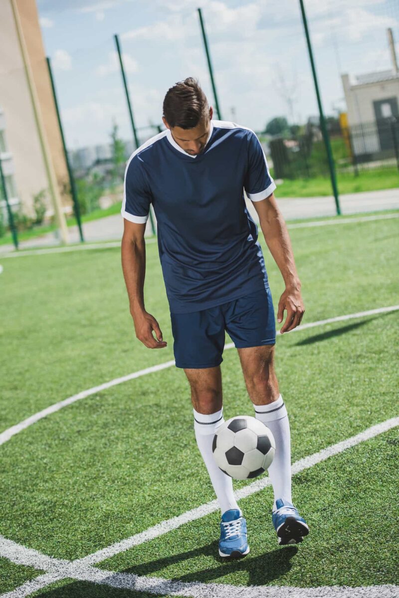 soccer-player-juggling-football-on-green-field-2026-03-11-04-11-13-utc
