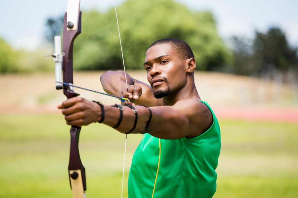 Athlete practicing archery in stadium