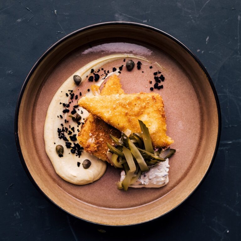 Black desk, black background.