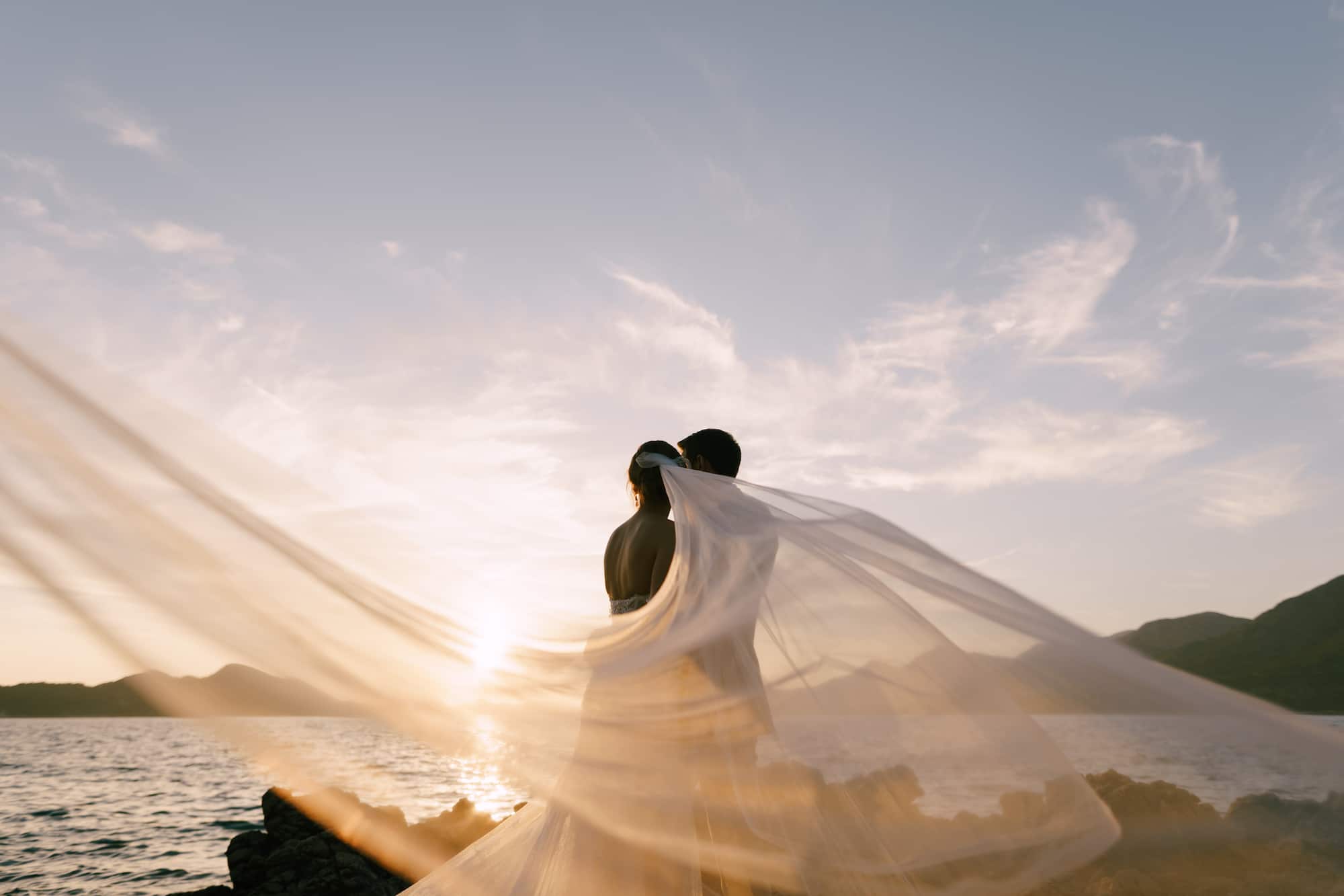 couple-celebrate-wedding-on-rocky-shoreline-at-sun-2026-03-17-00-03-13-utc