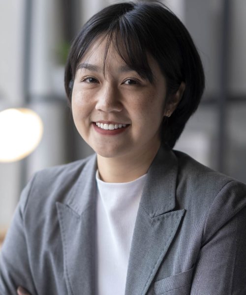 business-woman-smiling-in-office-with-graphs-2026-01-11-10-34-41-utc