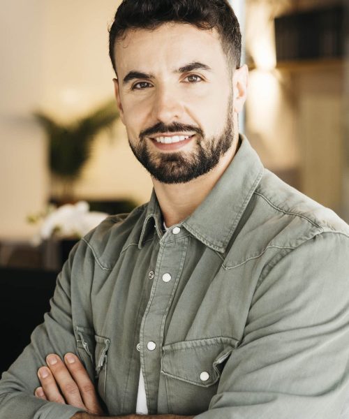 professional-man-confidently-smiling-standing-in-m-2026-03-26-10-31-53-utc