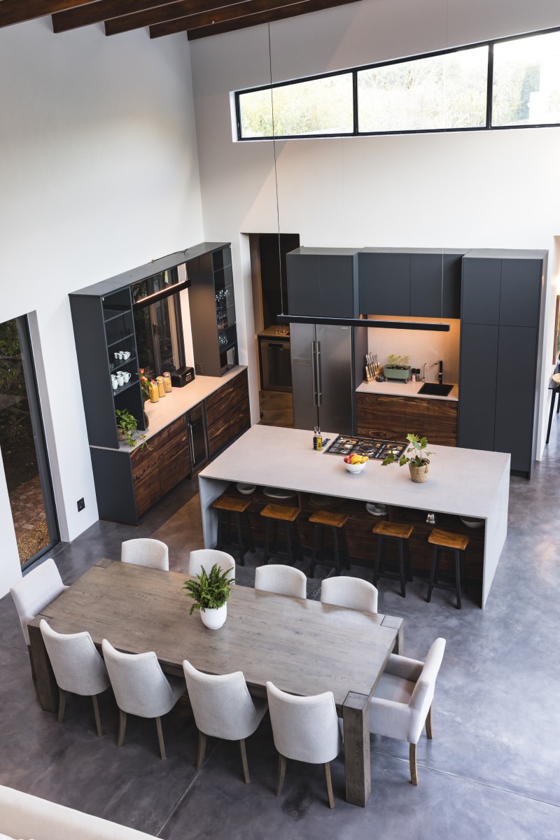 Modern kitchen and dining area with large table and stylish decor in home, copy space
